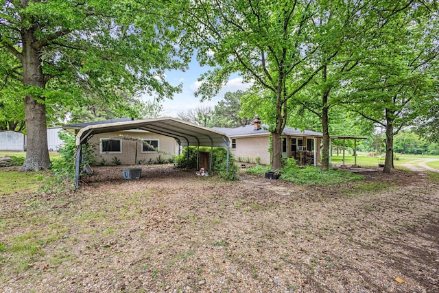 exterior space featuring a detached carport and a chimney