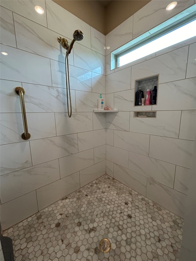 full bathroom with a tile shower