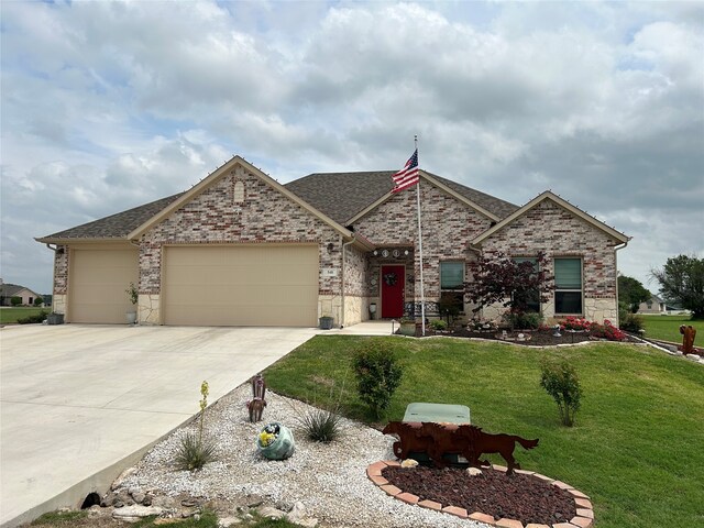540 Islet Dr, Runaway Bay, TX 76426 - view of front of house with a garage, concrete driveway, a front lawn, a shingled roof, and brick siding