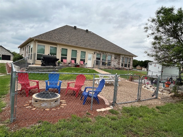540 Islet Dr, Runaway Bay, TX 76426 - back of property featuring a fire pit and roof with shingles