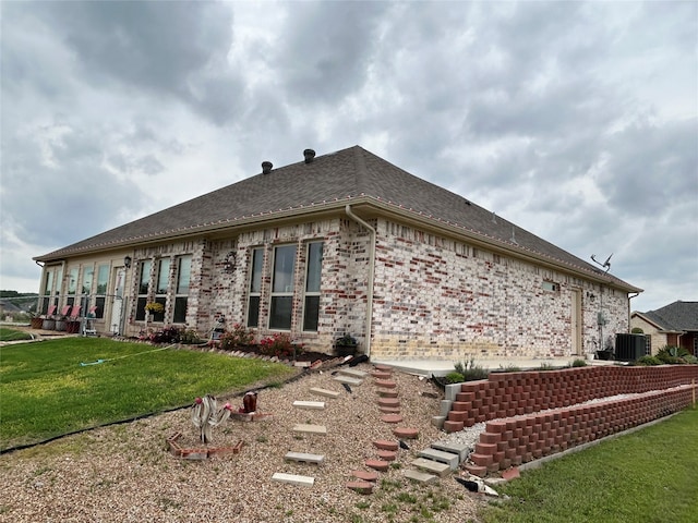 540 Islet Dr, Runaway Bay, TX 76426 - view of home's exterior with a lawn, brick siding, and roof with shingles