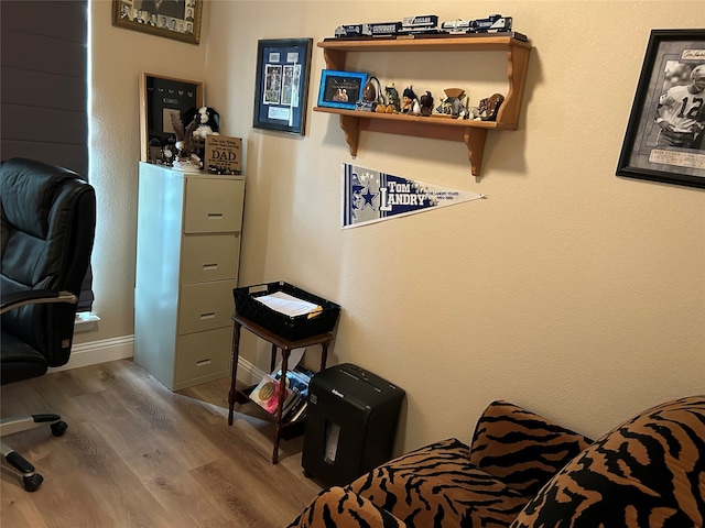bedroom featuring baseboards and wood finished floors