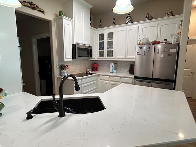 540 Islet Dr, Runaway Bay, TX 76426 - kitchen featuring appliances with stainless steel finishes, a sink, white cabinets, and backsplash