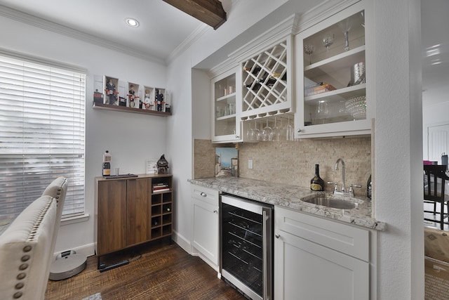 bar with wine cooler, indoor wet bar, dark wood-type flooring, a sink, and backsplash