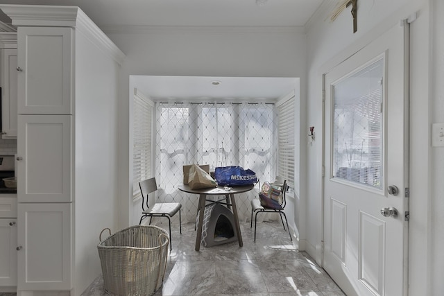 dining room featuring crown molding, baseboards, and marble finish floor