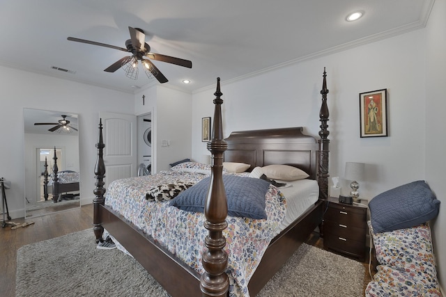 bedroom with visible vents, stacked washer and clothes dryer, crown molding, wood finished floors, and recessed lighting
