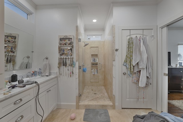 bathroom with crown molding, a wealth of natural light, vanity, and a stall shower