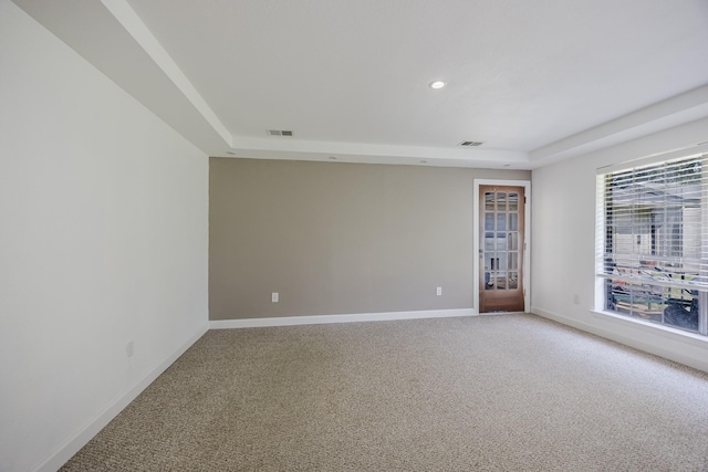 703 Athenia Way, Duncanville, TX 75137 - spare room with light colored carpet, a raised ceiling, baseboards, and recessed lighting