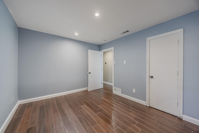 703 Athenia Way, Duncanville, TX 75137 - unfurnished bedroom with dark wood finished floors, baseboards, and recessed lighting