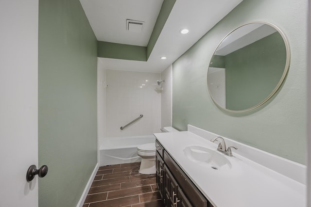 703 Athenia Way, Duncanville, TX 75137 - bathroom featuring vanity, toilet, wood finish floors, baseboards, and  shower combination