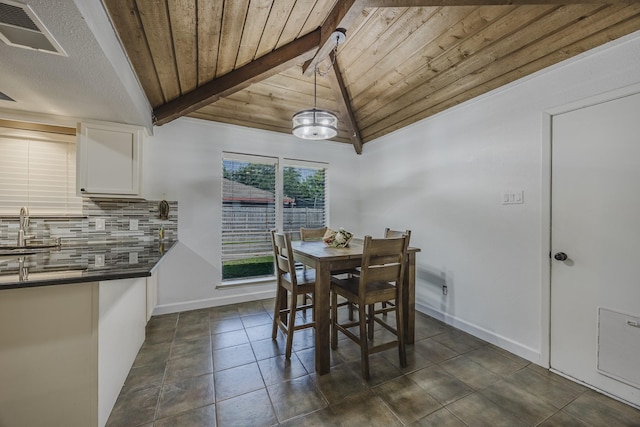 703 Athenia Way, Duncanville, TX 75137 - dining area with wood ceiling, baseboards, and dark tile patterned flooring
