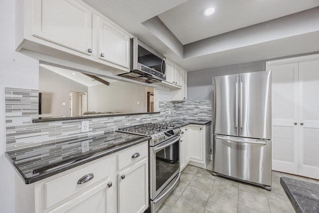 703 Athenia Way, Duncanville, TX 75137 - kitchen with stainless steel appliances, white cabinets, light tile patterned flooring, decorative backsplash, and recessed lighting