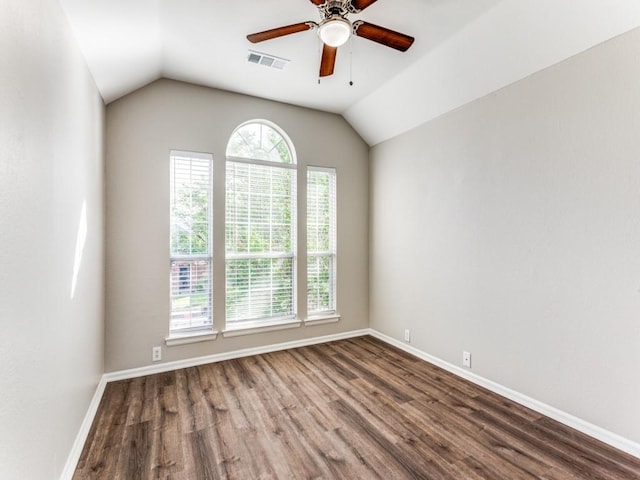 spare room featuring a ceiling fan, baseboards, wood finished floors, lofted ceiling, and visible vents