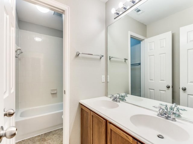 full bathroom with double vanity, visible vents, and a sink