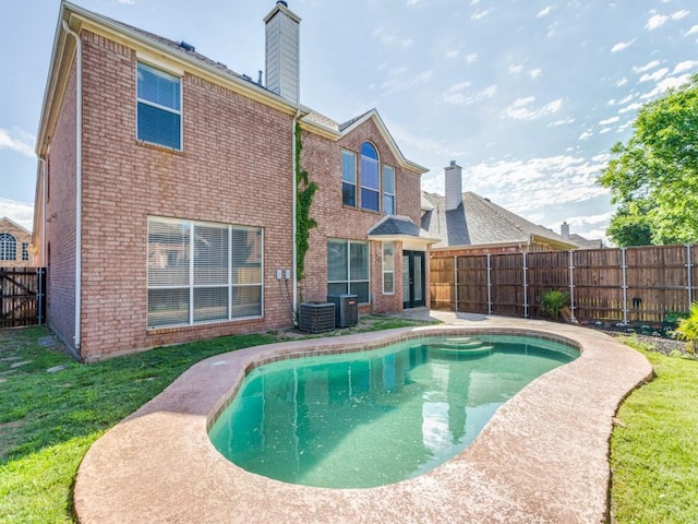 view of pool featuring a yard, a fenced in pool, a fenced backyard, and central air condition unit
