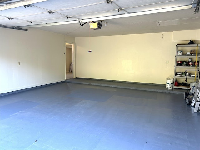 garage featuring baseboards and a garage door opener