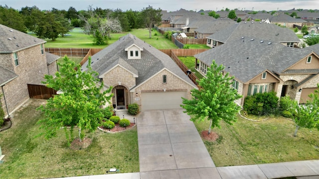 4010 Knightsbridge Ln, Midlothian, TX 76065 - view of front facade with a residential view, stone siding, a garage, a fenced backyard, and concrete driveway