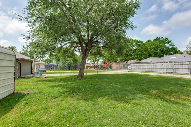view of yard with a playground and fence