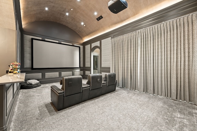 carpeted home theater featuring recessed lighting, arched walkways, and lofted ceiling