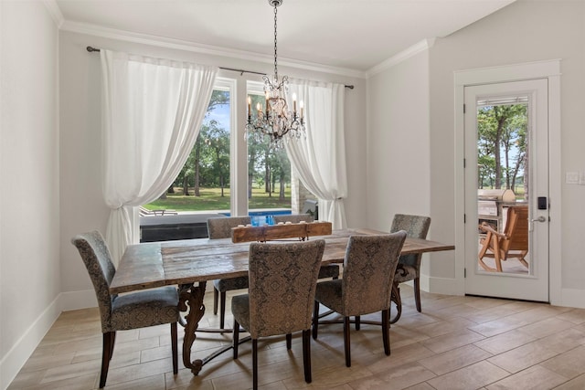 dining space with light wood-style floors, ornamental molding, a notable chandelier, and a healthy amount of sunlight