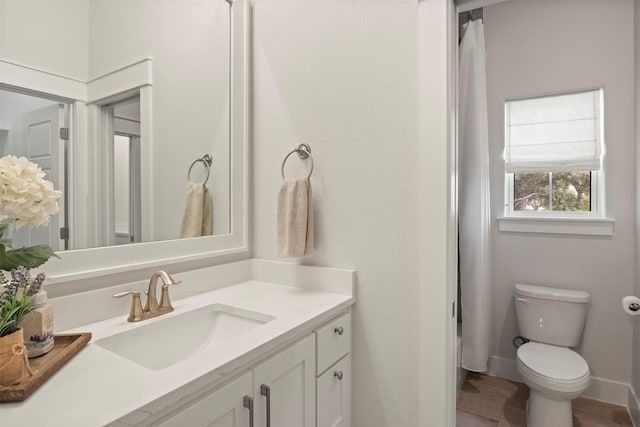 full bathroom with vanity, wood finished floors, and toilet