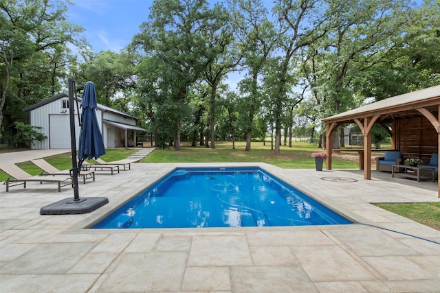 outdoor pool with a lawn, a patio, a gazebo, and an outdoor structure