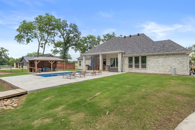 rear view of house with outdoor lounge area, a fenced backyard, a patio area, a gazebo, and a yard