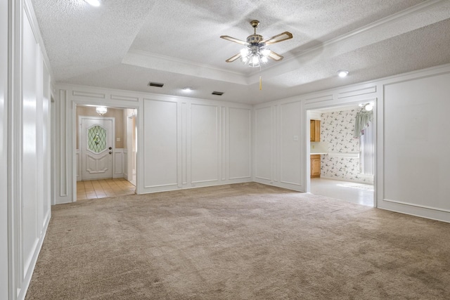 interior space with visible vents, light carpet, ensuite bathroom, and a decorative wall