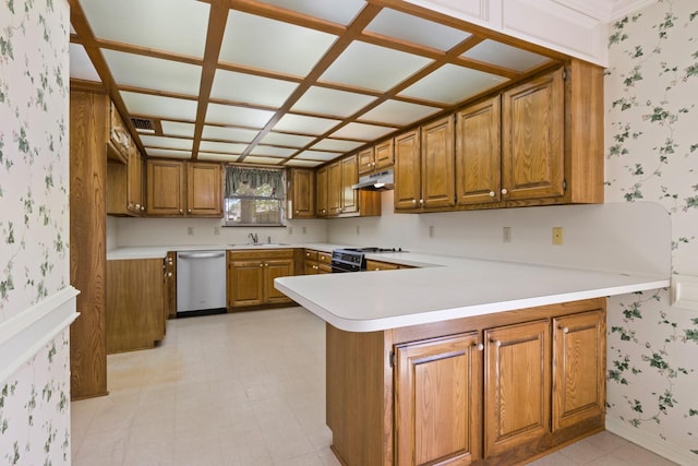 kitchen featuring stainless steel dishwasher, brown cabinetry, under cabinet range hood, and wallpapered walls