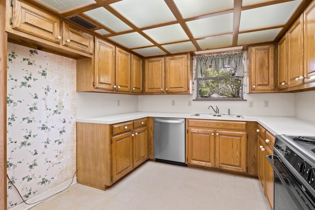 kitchen with range with electric cooktop, brown cabinetry, a sink, and dishwasher