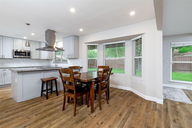 dining area featuring recessed lighting, a wealth of natural light, and light wood finished floors
