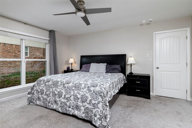 carpeted bedroom with baseboards and a ceiling fan