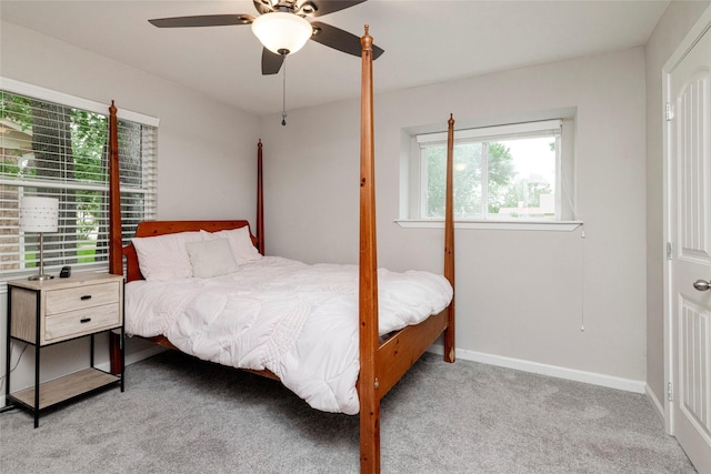 bedroom featuring ceiling fan, light carpet, and baseboards