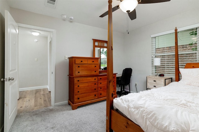 carpeted bedroom featuring visible vents, baseboards, and ceiling fan