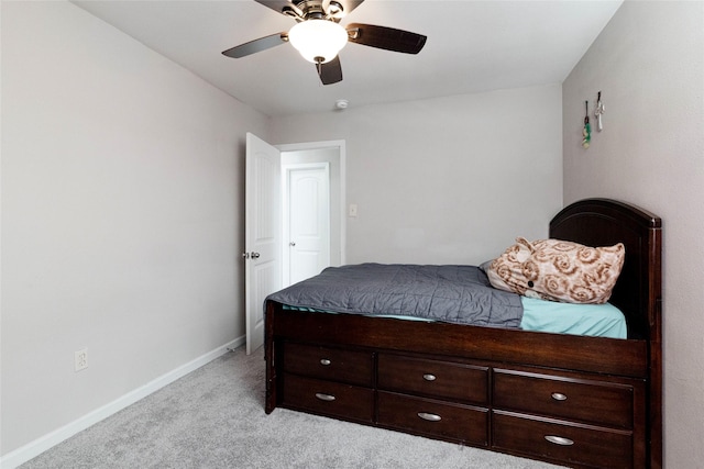 bedroom featuring a ceiling fan, baseboards, and light colored carpet