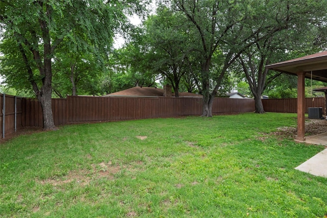 view of yard featuring a fenced backyard and central air condition unit