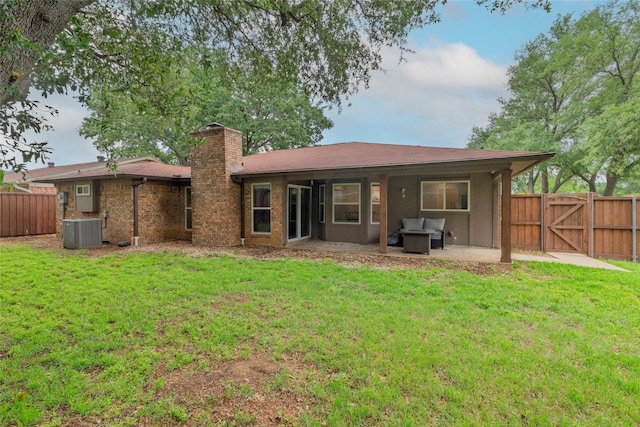 rear view of property with a lawn, a fenced backyard, a patio area, and a chimney