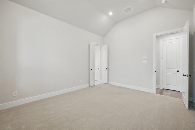 1851 Rosedale Ave, Van Alstyne, TX 75495 - unfurnished bedroom with baseboards, light carpet, visible vents, and vaulted ceiling