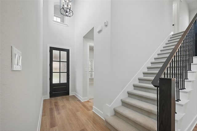 1851 Rosedale Ave, Van Alstyne, TX 75495 - entryway featuring wood finished floors, a notable chandelier, stairway, baseboards, and a towering ceiling