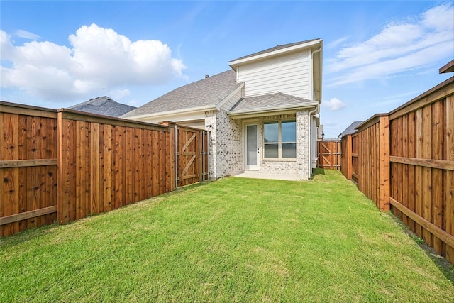 1851 Rosedale Ave, Van Alstyne, TX 75495 - rear view of house featuring a shingled roof, a yard, a gate, and a fenced backyard