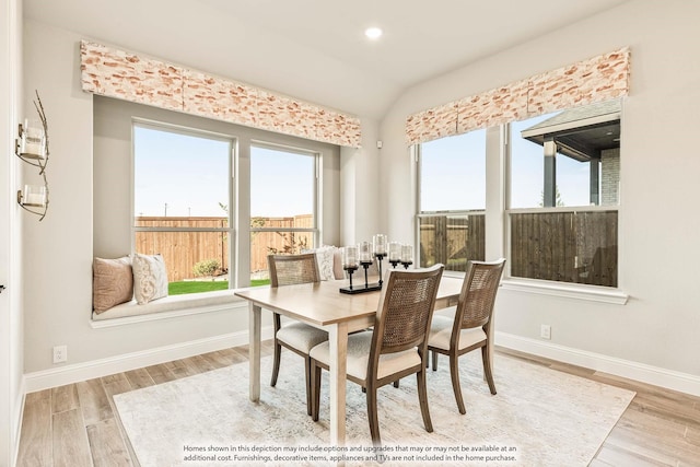 dining area featuring recessed lighting, baseboards, wood finished floors, and lofted ceiling