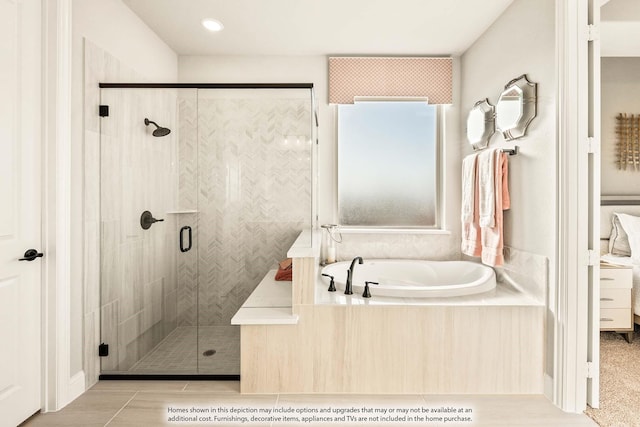 bathroom with a bath and a stall shower