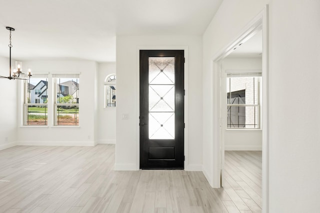801 Daisy Corner Dr, Little Elm, TX 76227 - entryway with light wood finished floors, a chandelier, and baseboards