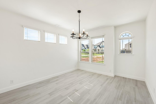801 Daisy Corner Dr, Little Elm, TX 76227 - spare room featuring a chandelier, light wood finished floors, and baseboards