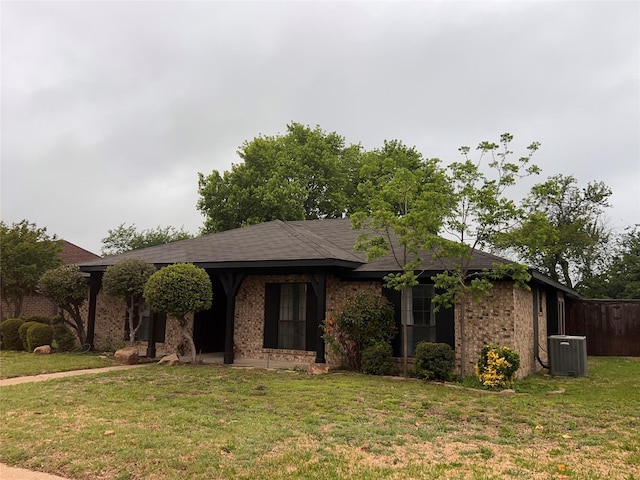 1005 Bass Dr, Plano, TX 75025 - ranch-style home featuring brick siding, a front lawn, and central air condition unit
