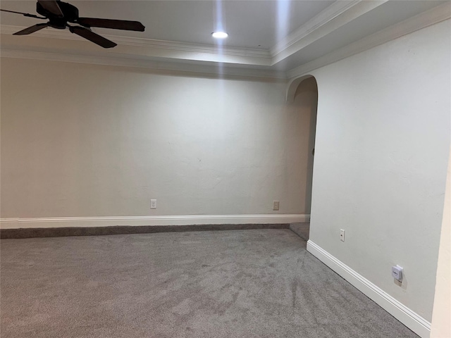 1005 Bass Dr, Plano, TX 75025 - carpeted spare room featuring a ceiling fan, crown molding, arched walkways, baseboards, and a tray ceiling