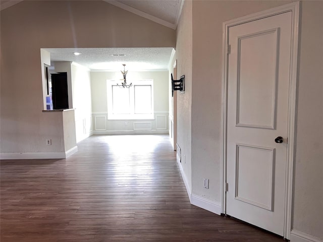 1005 Bass Dr, Plano, TX 75025 - corridor featuring crown molding, dark wood-style flooring, a notable chandelier, and lofted ceiling