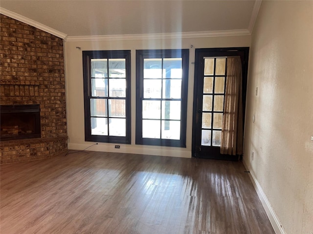 1005 Bass Dr, Plano, TX 75025 - unfurnished living room with crown molding, baseboards, a brick fireplace, and wood finished floors