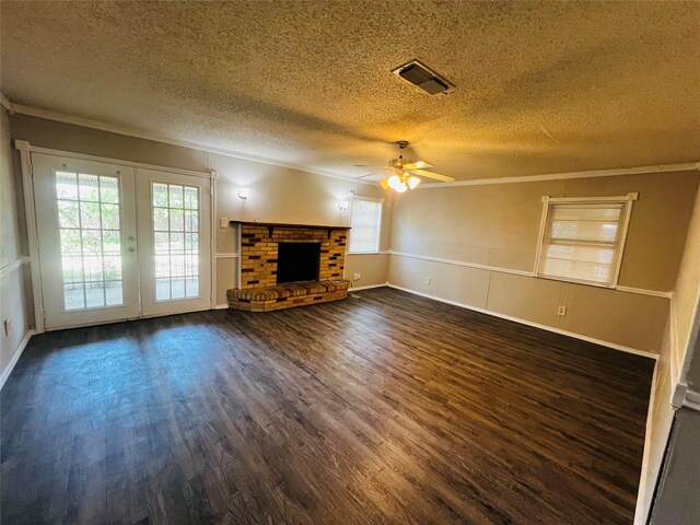 unfurnished living room featuring ornamental molding, dark wood finished floors, and a textured ceiling
