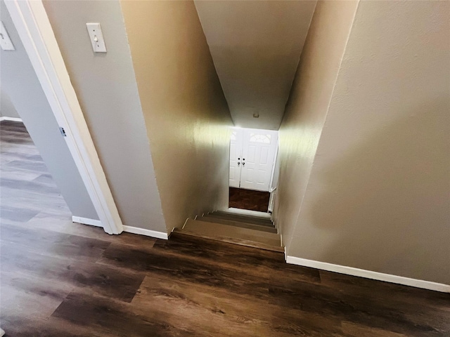 stairway with baseboards and wood finished floors